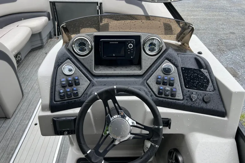 Slide: The Image of 2021 Sylvan L5 DLZ boat dashboard with steering wheel and control panel. - 8