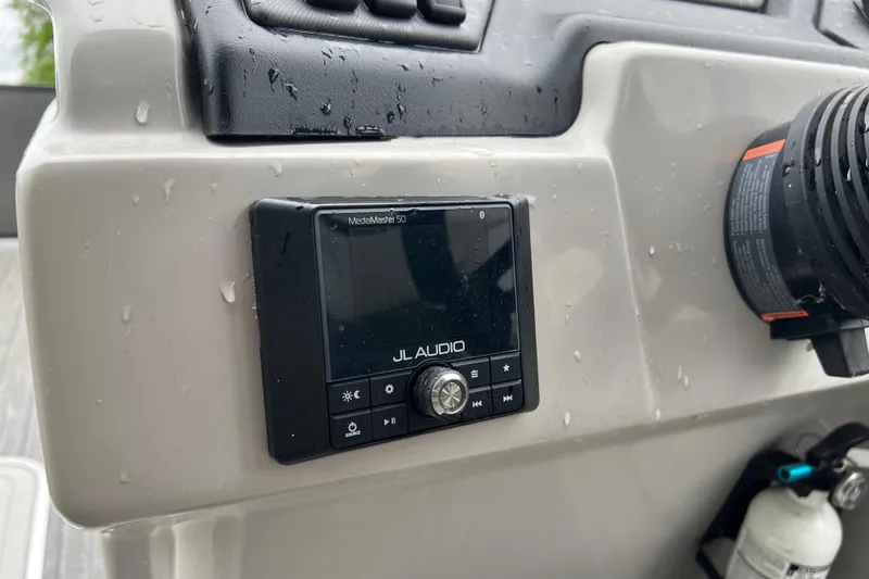 Slide: The Image of JL Audio MediaMaster 50 installed on 2021 Sylvan L5 DLZ boat dashboard. - 9
