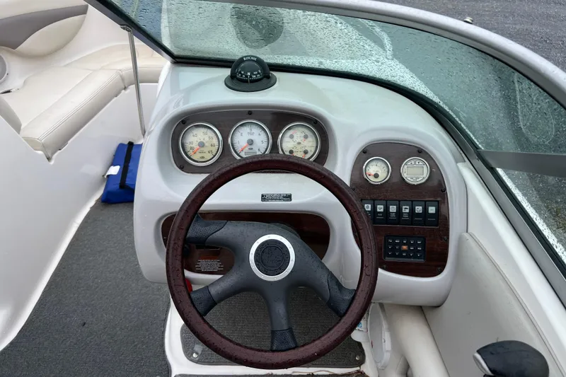 Slide: The Image of Steering wheel and dashboard of 2005 Chaparral 204 SSi boat, featuring gauges and controls. - 6