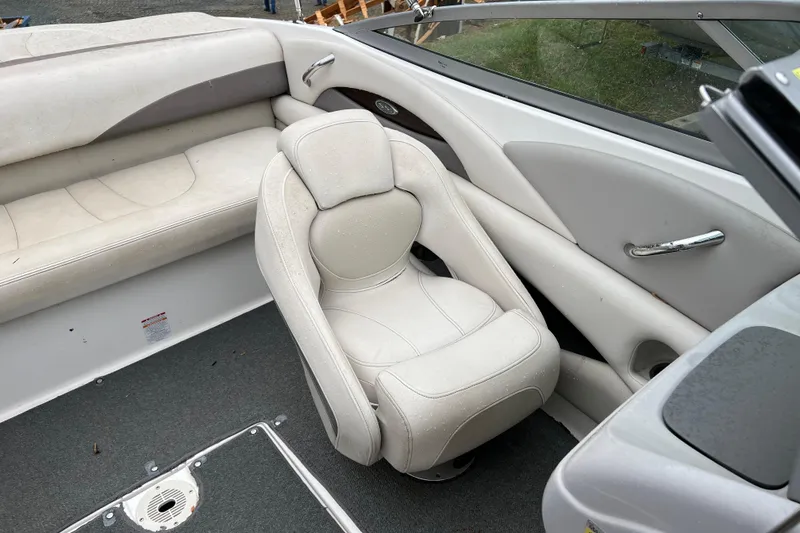Slide: The Image of 2005 Chaparral 204 SSi boat interior with white seating and gray carpet. - 9
