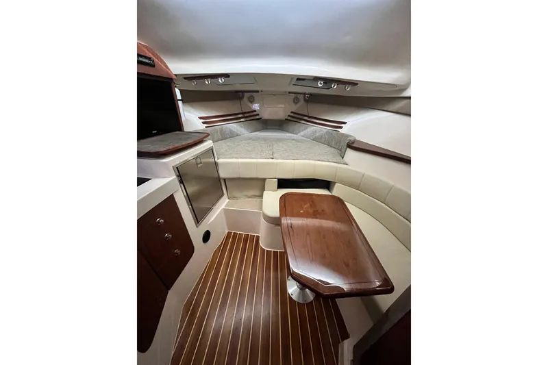 Slide: The Image of 2017 Grady-White Express 330 cabin interior with wood accents and seating area. - 13