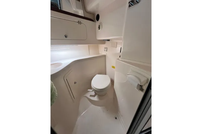 Slide: The Image of 2017 Grady-White Express 330 boat bathroom interior with toilet and storage. - 14