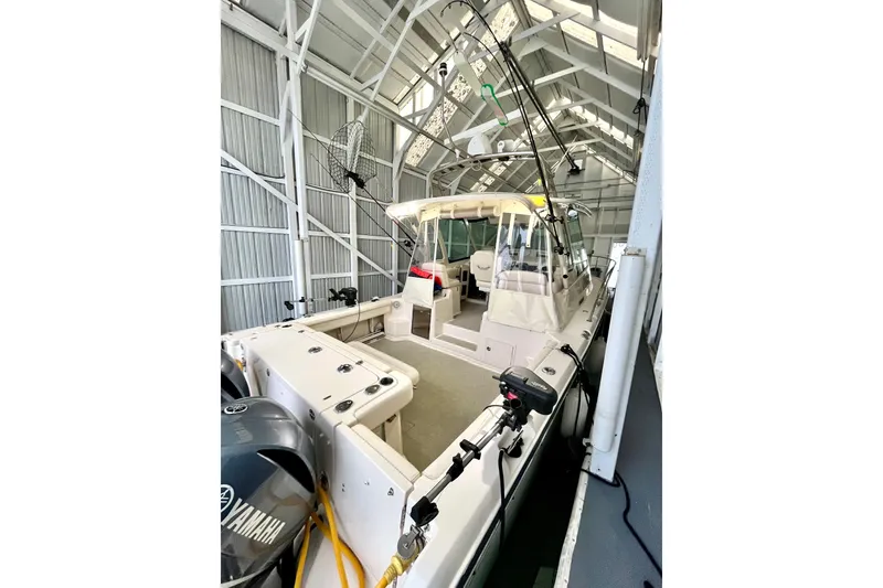 Slide: The Image of 2017 Grady-White Express 330 boat in a covered storage facility, featuring Yamaha engines. - 3