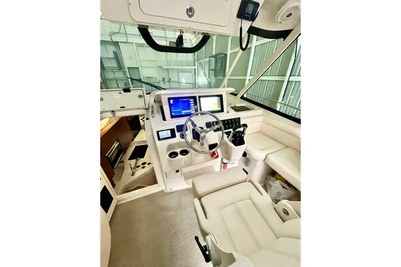 Slide: The Image of 2017 Grady-White Express 330 helm with modern navigation displays and comfortable seating. - 9