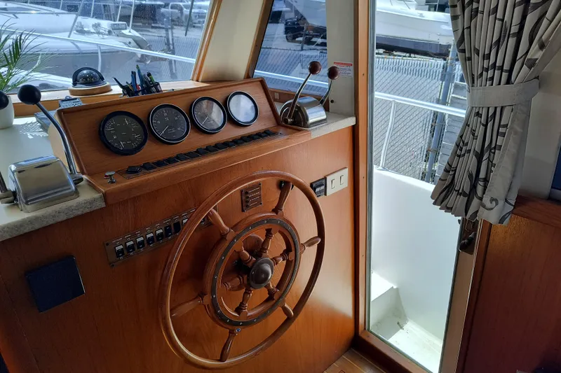 Slide: The Image of 2000 Mainship 390 Trawler helm with wooden wheel and instrument panel. - 12