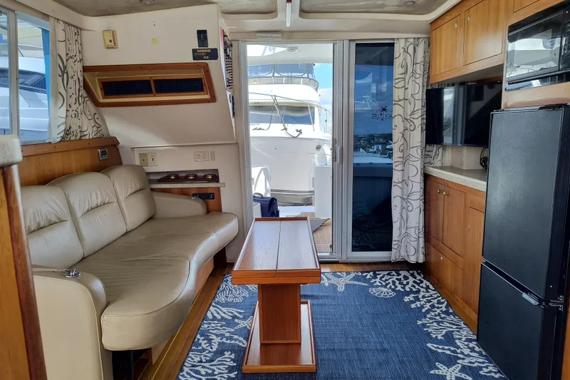 Slide: The Image of Interior of 2000 Mainship 390 Trawler with sofa, table, and kitchenette. - 13