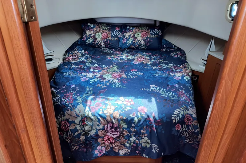 Slide: The Image of Cozy cabin bedroom in 2000 Mainship 390 Trawler with floral bedding. - 15