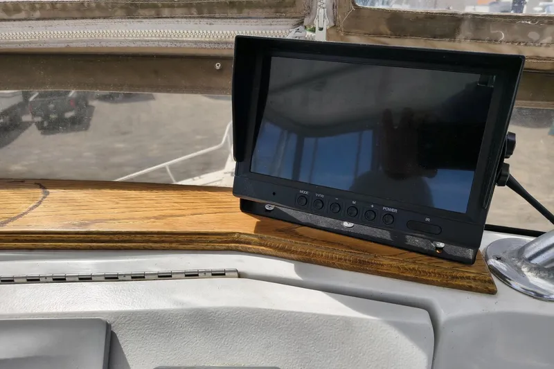 Slide: The Image of Control panel of a 2000 Mainship 390 Trawler with a mounted display screen. - 25