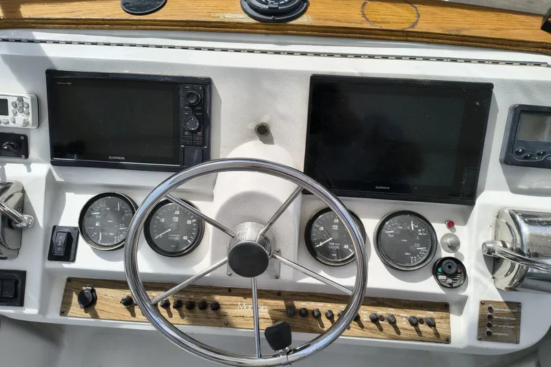 Slide: The Image of Mainship 390 Trawler 2000 helm with Garmin displays and navigational instruments. - 27