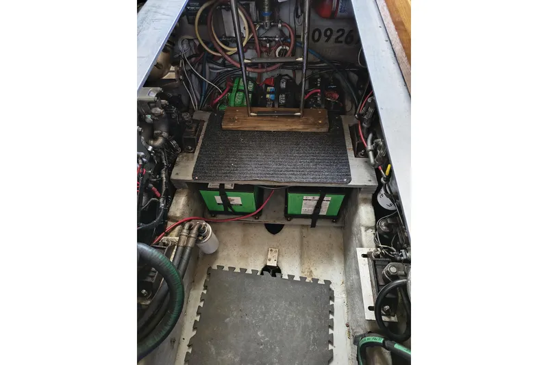 Slide: The Image of Engine room of 2000 Mainship 390 Trawler with batteries and wiring. - 32