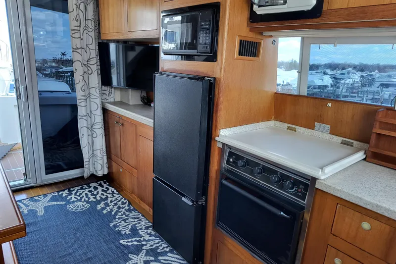 Slide: The Image of Kitchen area of 2000 Mainship 390 Trawler with appliances and window view. - 8