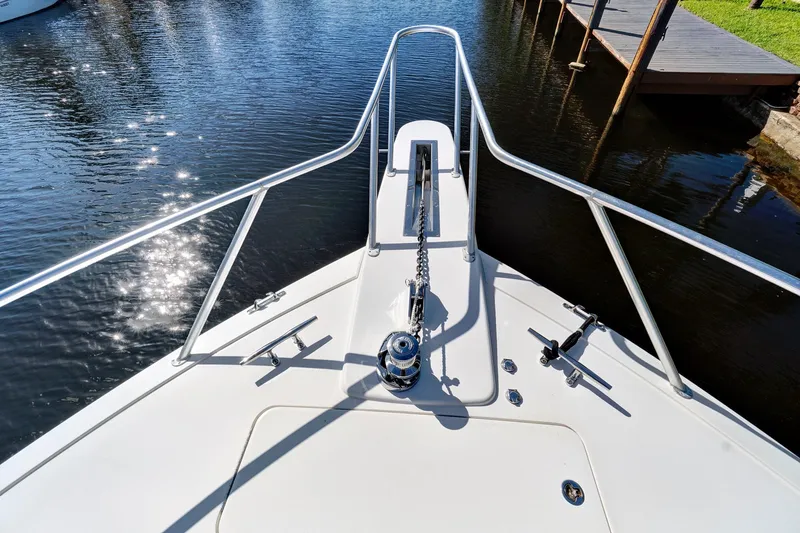 Slide: The Image of Bow view of 2008 Viking 74 Enclosed Bridge yacht with anchor chain and railings. - 12