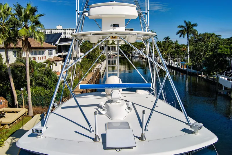 Slide: The Image of 2008 Viking 74 Enclosed Bridge yacht docked in a scenic canal setting. - 15