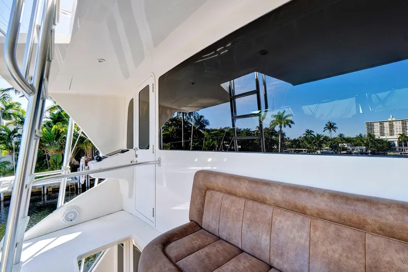 Slide: The Image of 2008 Viking 74 Enclosed Bridge yacht with outdoor seating and scenic waterfront view. - 22