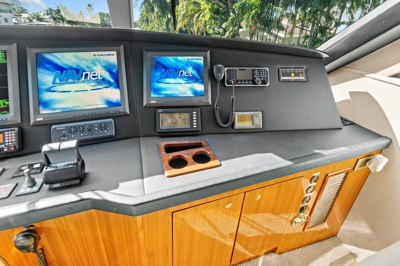 Slide: The Image of Cockpit of 2008 Viking 74 Enclosed Bridge yacht with navigation screens and controls. - 29