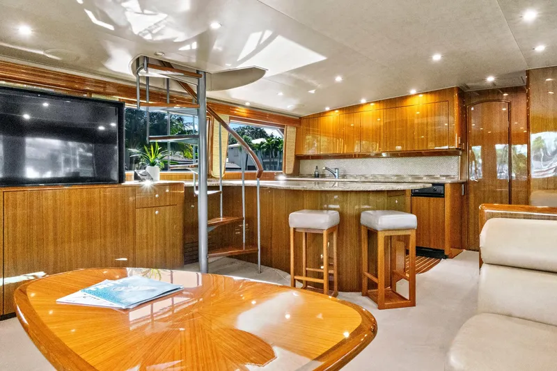 Slide: The Image of Luxurious interior of 2008 Viking 74 Enclosed Bridge yacht with modern kitchen and seating area. - 38