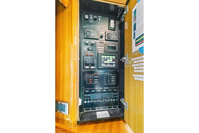 Slide: The Image of Electrical panel inside 2008 Viking 74 Enclosed Bridge yacht, featuring various switches and controls. - 43