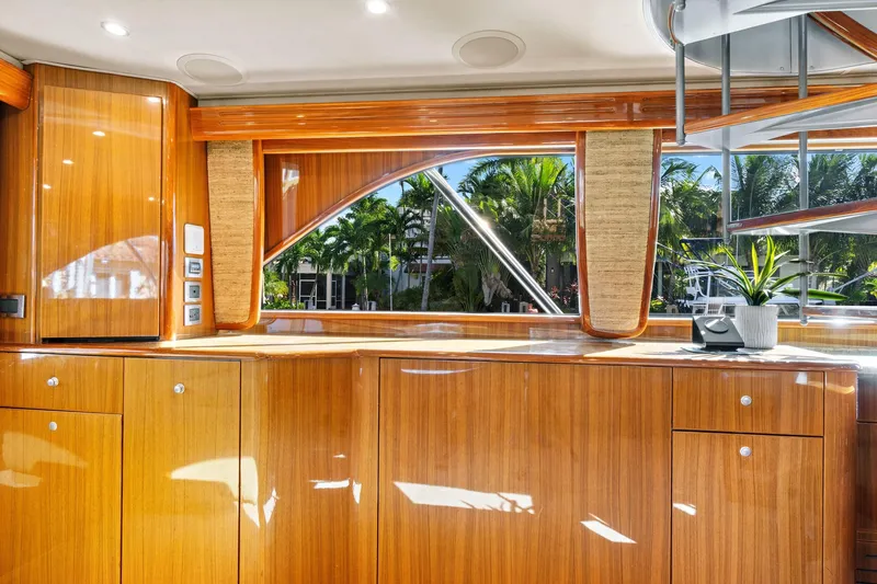 Slide: The Image of Luxurious interior of 2008 Viking 74 Enclosed Bridge yacht with polished wood cabinetry. - 44