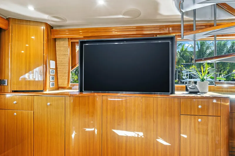 Slide: The Image of Luxurious interior of 2008 Viking 74 Enclosed Bridge yacht with wooden cabinetry and flat-screen TV. - 45