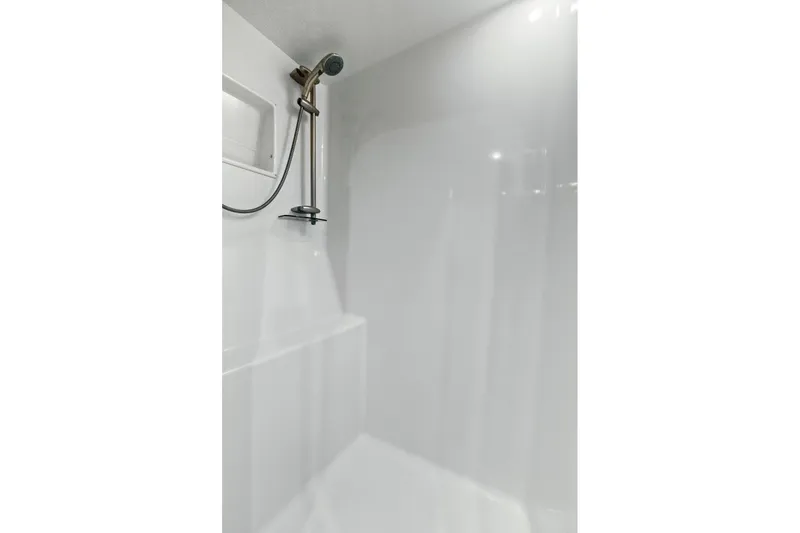Slide: The Image of Shower area in 2008 Viking 74 Enclosed Bridge yacht, featuring sleek white design and modern fixtures. - 54
