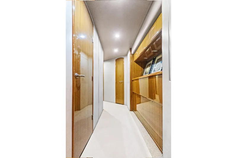 Slide: The Image of Luxurious hallway interior of 2008 Viking 74 Enclosed Bridge yacht with wooden finishes. - 55