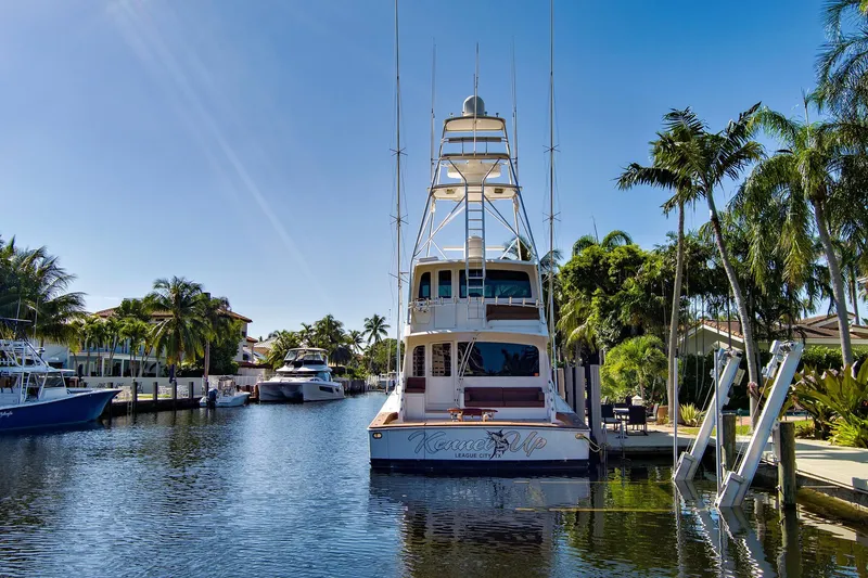 Slide: The Image of Luxury 2008 Viking 74 Enclosed Bridge yacht docked in a sunny, tropical marina. - 6