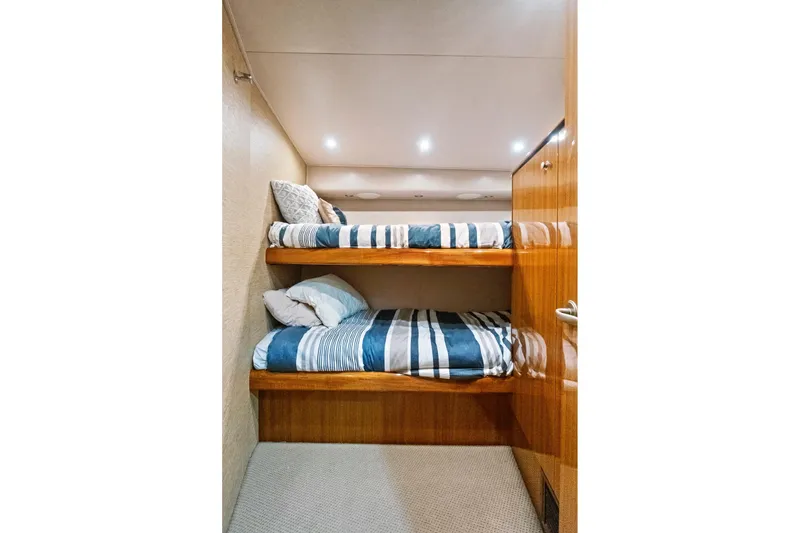 Slide: The Image of Bunk beds in 2008 Viking 74 Enclosed Bridge yacht cabin with striped bedding. - 60