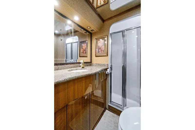 Slide: The Image of Luxurious bathroom in 2008 Viking 74 Enclosed Bridge yacht with granite countertop and shower. - 65