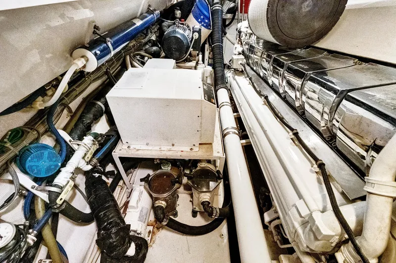 Slide: The Image of Engine room of 2008 Viking 74 Enclosed Bridge yacht, showcasing mechanical components and systems. - 71
