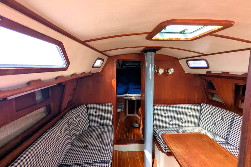 Slide: The Image of Interior of 1980 SCEPTRE 36 sailboat with wood paneling and checkered seating. - 16