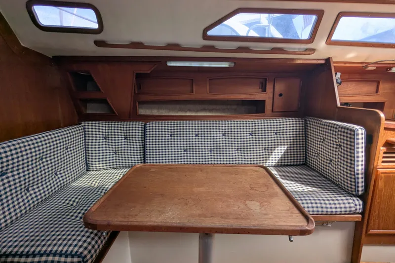 Slide: The Image of Cozy interior of 1980 SCEPTRE 36 sailboat with checkered seating and wooden table. - 17