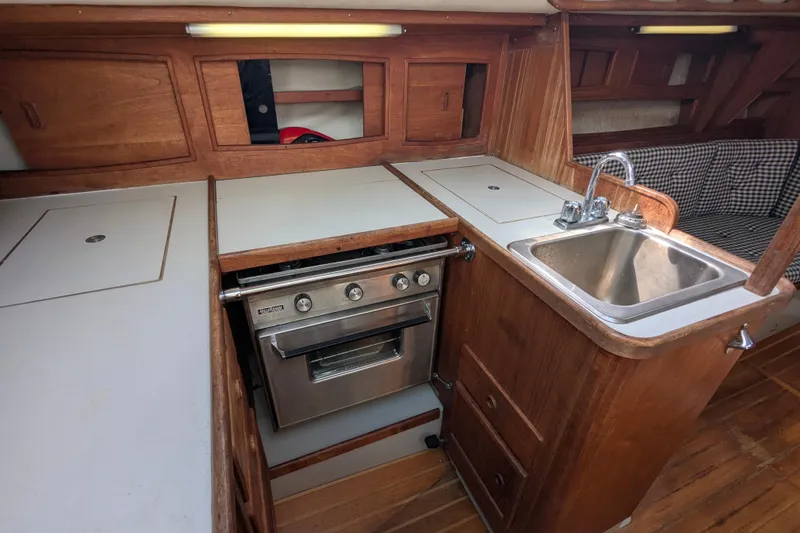 Slide: The Image of Interior of 1980 SCEPTRE 36 yacht kitchen with stove, sink, and wooden cabinetry. - 18