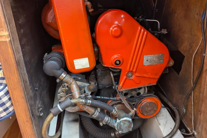 Slide: The Image of Engine compartment of a 1980 SCEPTRE 36 boat, featuring vibrant orange components. - 28