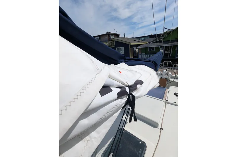 Slide: The Image of 1980 SCEPTRE 36 sailboat deck with neatly folded sails and clear sky. - 33
