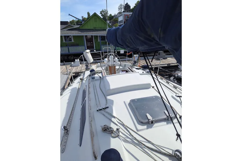 Slide: The Image of 1980 SCEPTRE 36 sailboat deck view at dock, featuring rigging and hatch. - 5