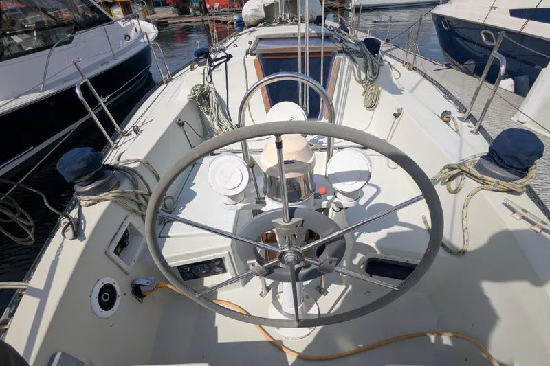 Slide: The Image of Cockpit of a 1980 SCEPTRE 36 sailboat with steering wheel and nautical equipment. - 7