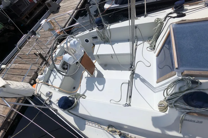 Slide: The Image of 1980 SCEPTRE 36 sailboat cockpit with steering wheel, ropes, and docked at a marina. - 8