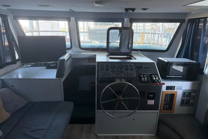 Slide: The Image of Interior of a 1996 Gibson Sport 41 boat with helm, TV, and microwave. - 3