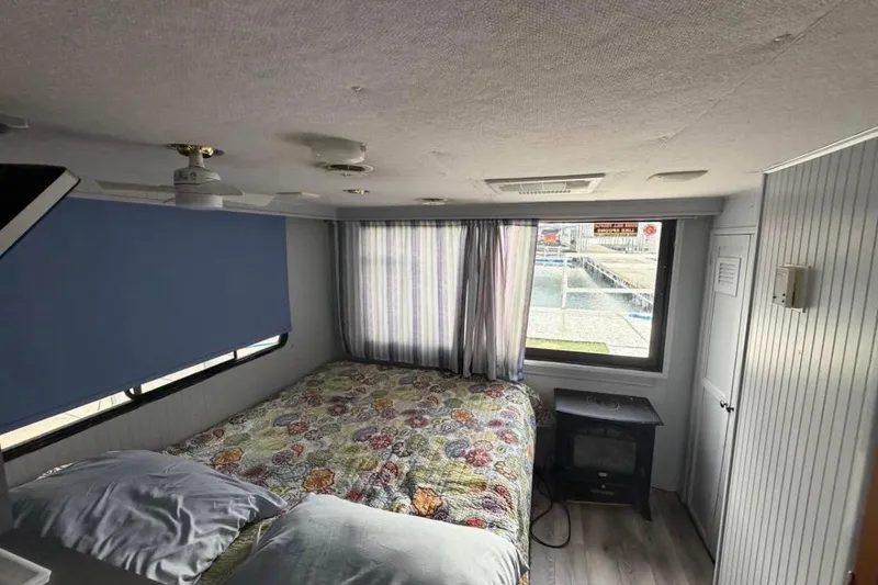 Slide: The Image of Cozy bedroom in 1996 Gibson Sport 41 boat with floral bedding and window view. - 6