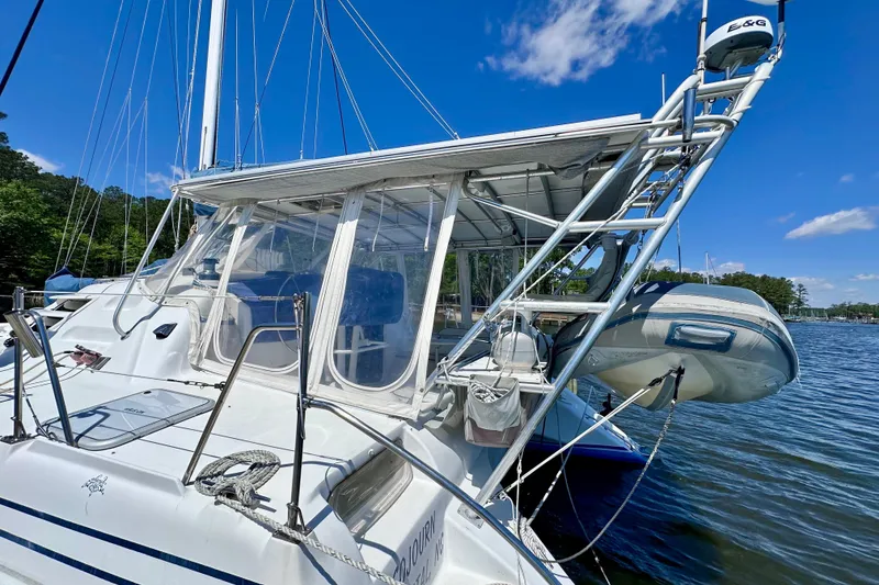 Slide: The Image of Sailing catamaran Manta 40, 1998 model, docked with clear skies and calm waters. - 100