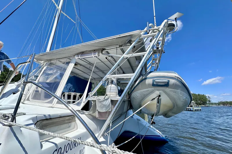 Slide: The Image of 1998 Manta 40 sailboat with dinghy, docked on a sunny day. - 101