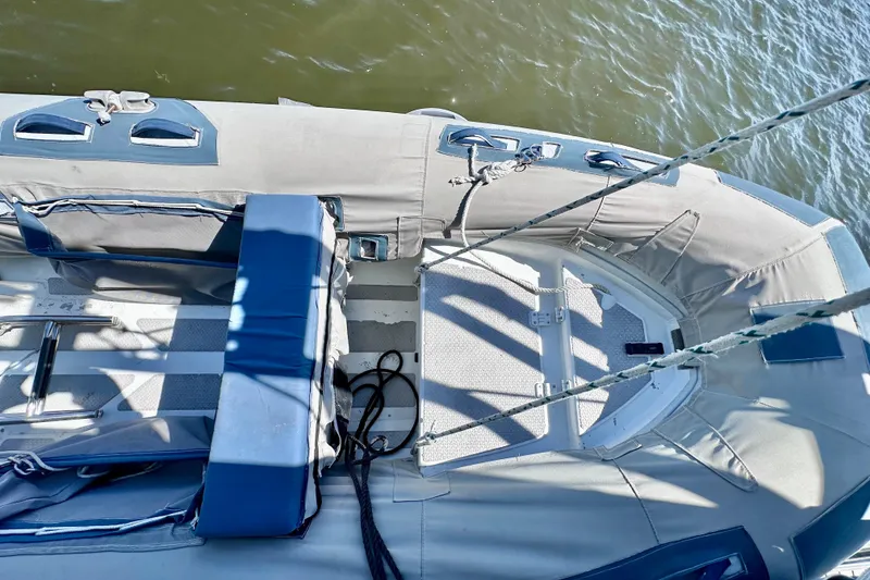 Slide: The Image of 1998 Manta 40 sailboat deck with ropes and seating, floating on water. - 108