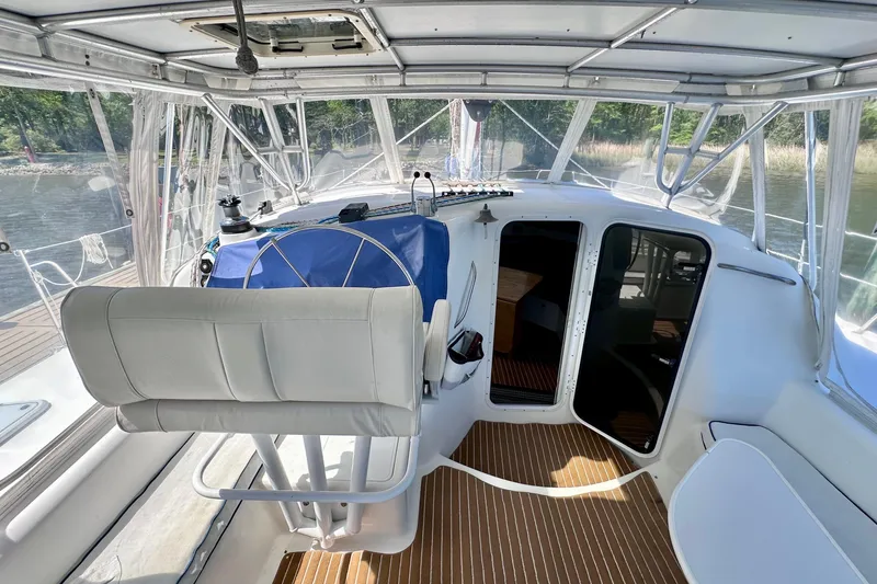 Slide: The Image of Cockpit of 1998 Manta 40 sailboat with helm, seating, and cabin entrance. - 109