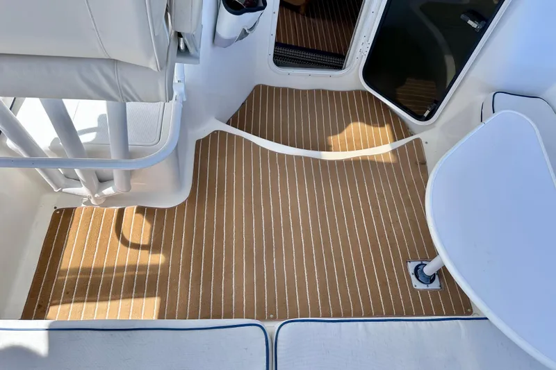 Slide: The Image of Interior of a 1998 Manta 40 boat with striped flooring and seating area. - 111