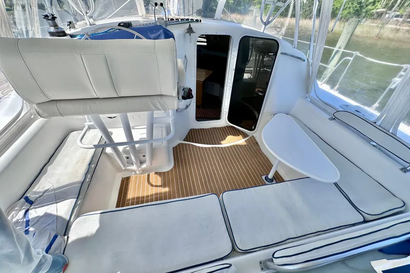 Slide: The Image of 1998 Manta 40 yacht cockpit with cushioned seating and wooden flooring. - 112