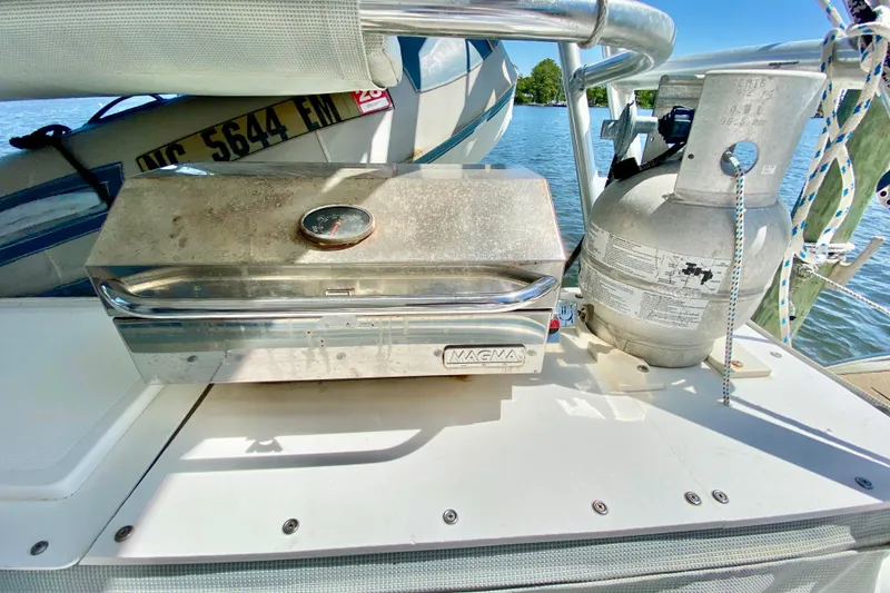 Slide: The Image of Stainless steel grill and propane tank on 1998 Manta 40 boat deck by the water. - 12