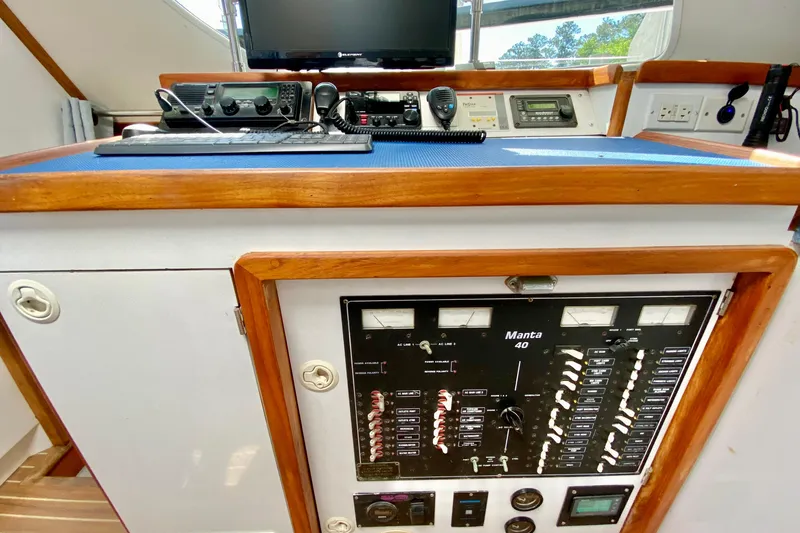 Slide: The Image of Control panel of a 1998 Manta 40 boat with navigation equipment and gauges. - 22