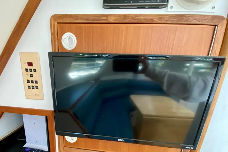 Slide: The Image of 1998 Manta 40 interior with mounted TV and control panel. - 35
