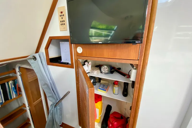 Slide: The Image of Interior of a 1998 Manta 40 boat with TV and storage cabinet. - 37
