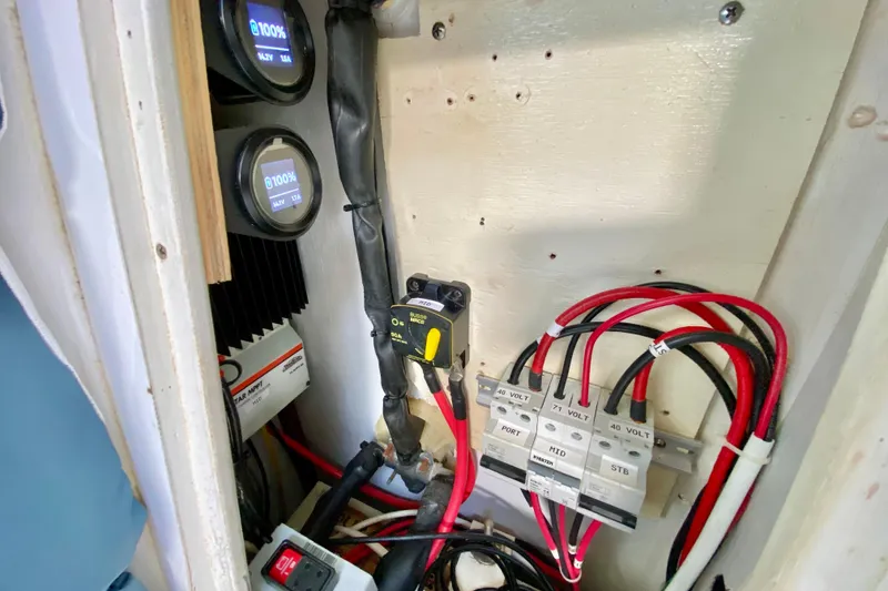 Slide: The Image of Electrical panel of a 1998 Manta 40 boat with gauges and wiring. - 38